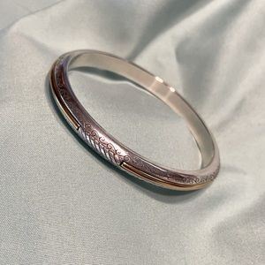 Silver Brighton bangle bracelet with gold accents.